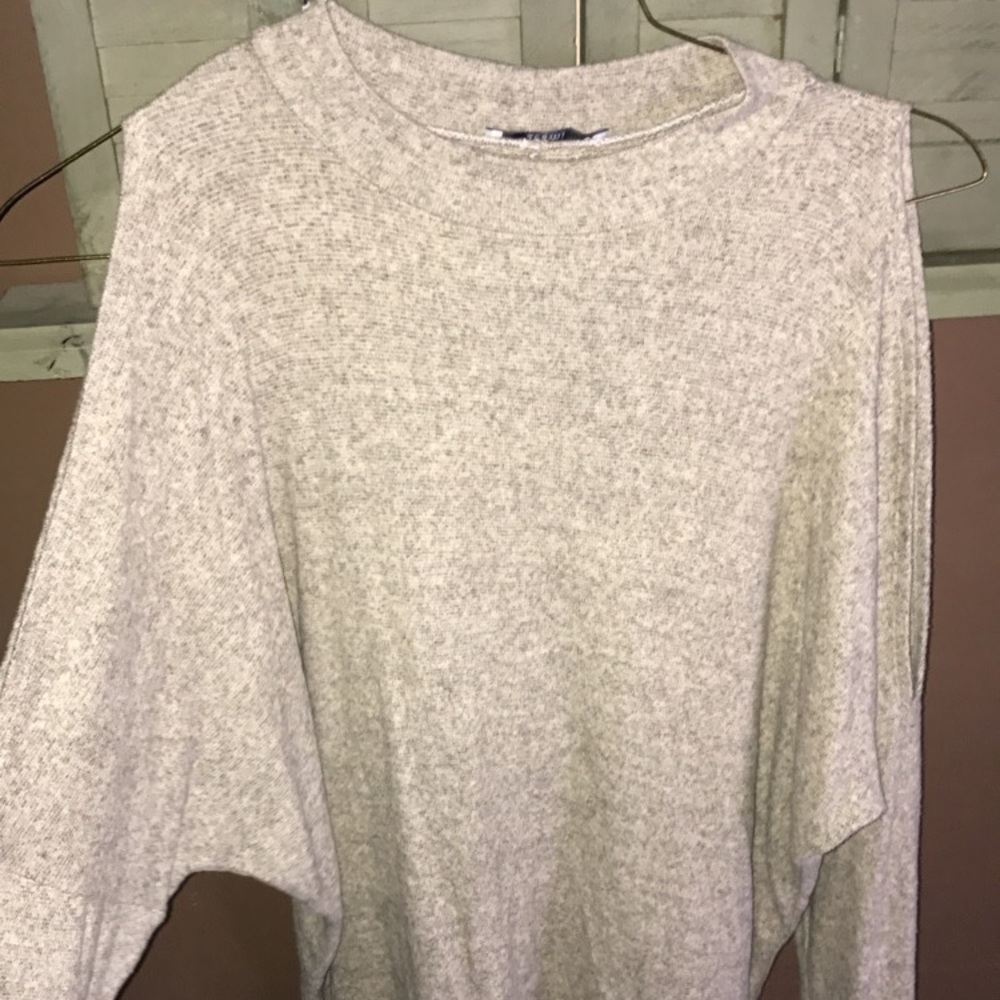 Cream colored long sleeve. Cutouts on the shoulder